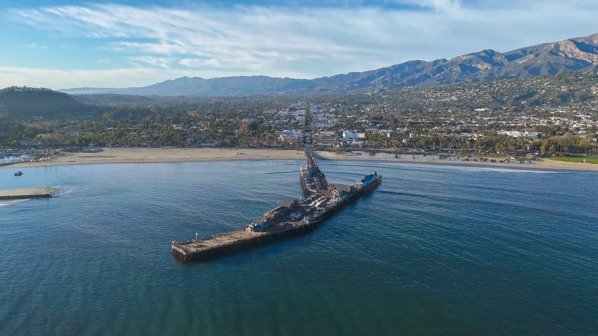 Golden-hour aerial of a Santa Barbara estate with the mountains beyond