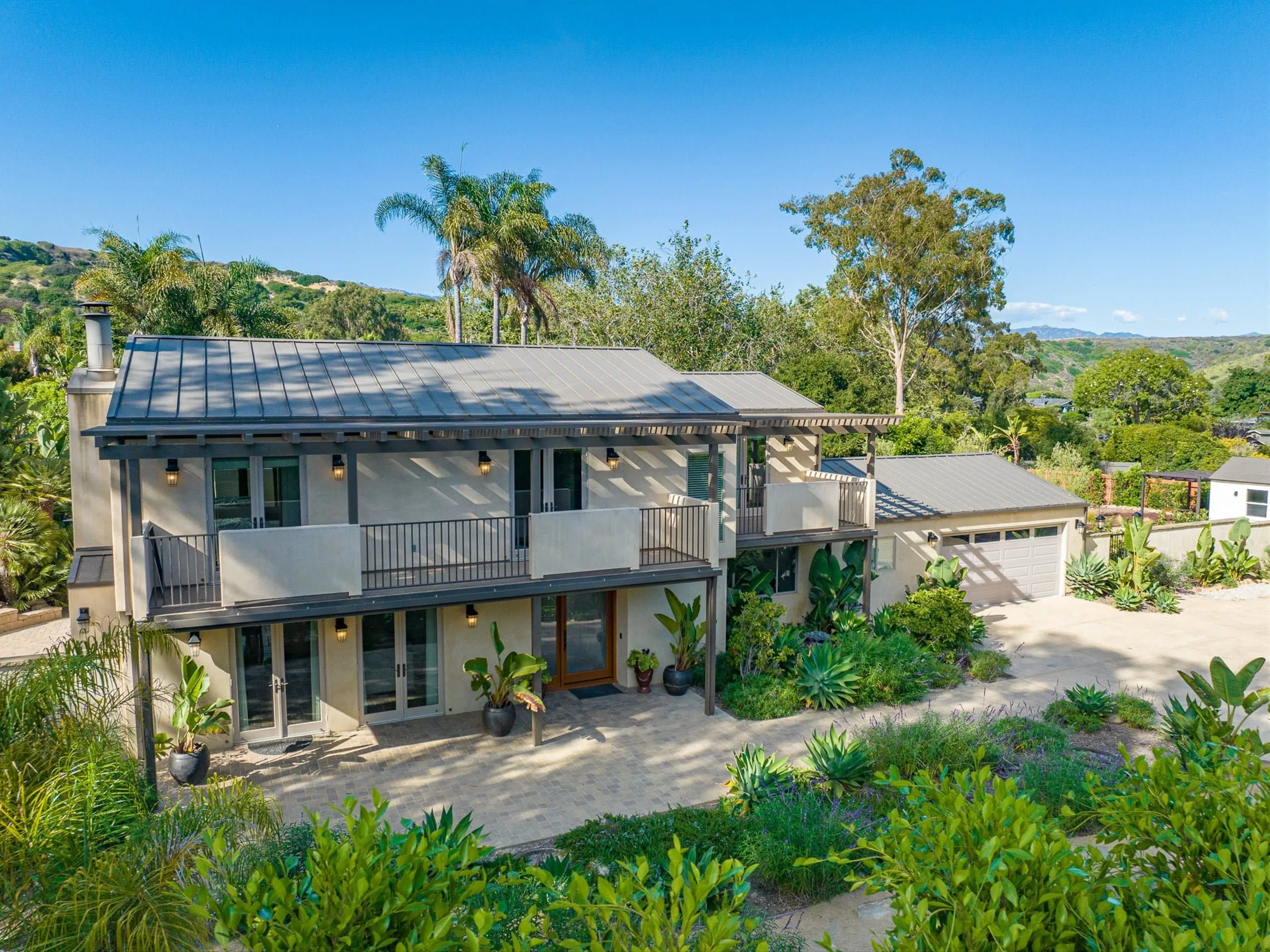 Two-story Santa Barbara home photographed from a raised angle at dusk
