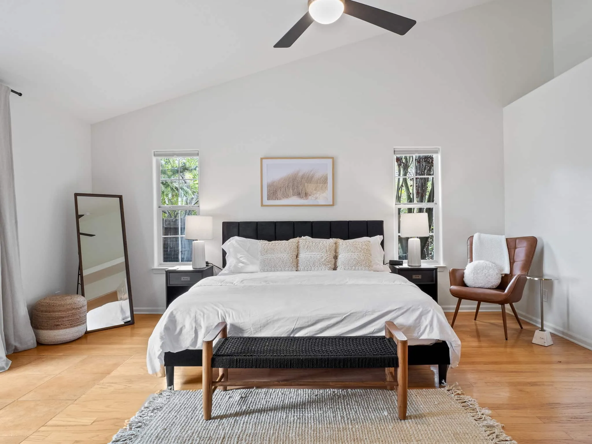 Primary bedroom with vaulted ceiling and natural light, ready for a virtual tour