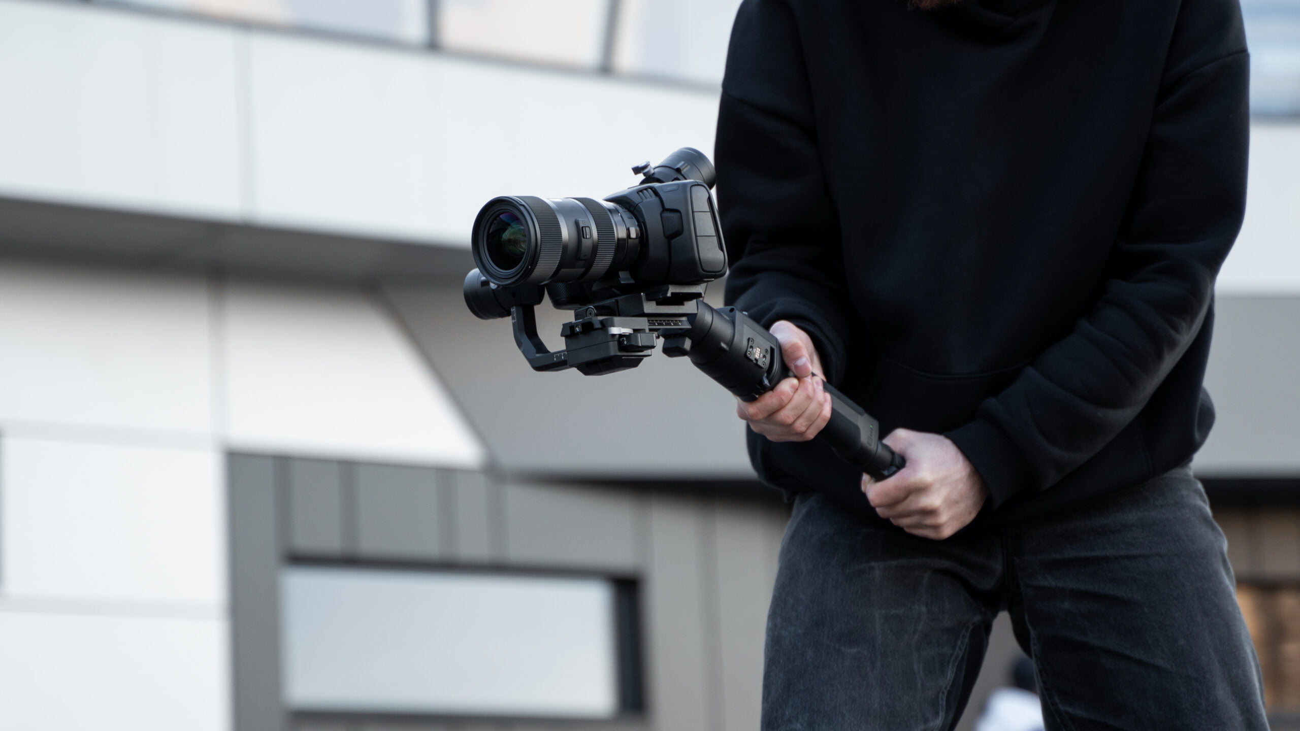 Videographer holding camera with gimbal for Cinematic Showing Videos, showcasing Drone-Enhanced Property Tours and creating Aerial Real Estate Showcases