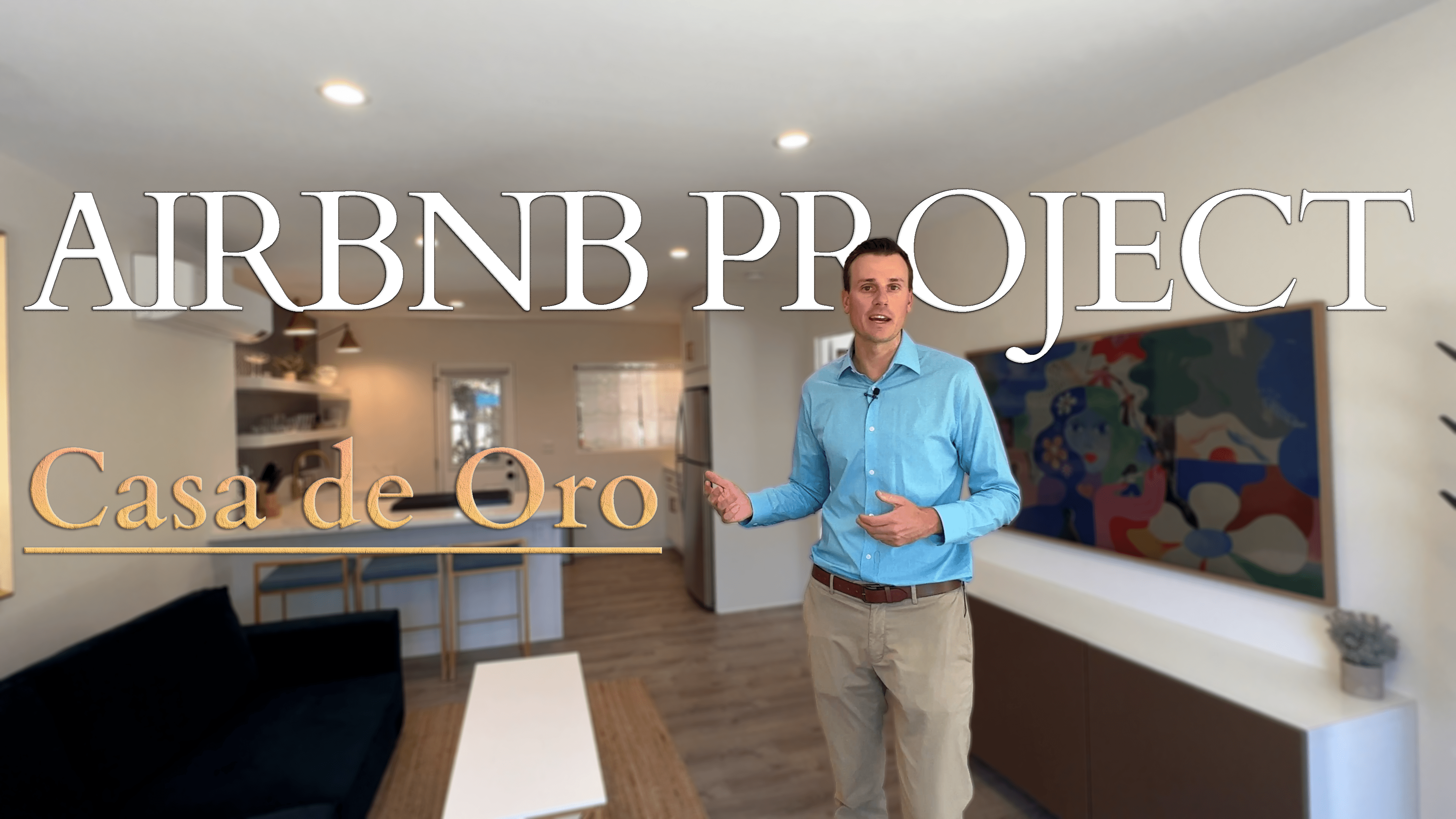 Man showcasing the AirBNB project Case de Oro with the property in the background.