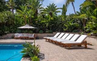 Luxury hotel poolside area with lounge chairs captured by professional drone photography for enhanced marketing and virtual tours.